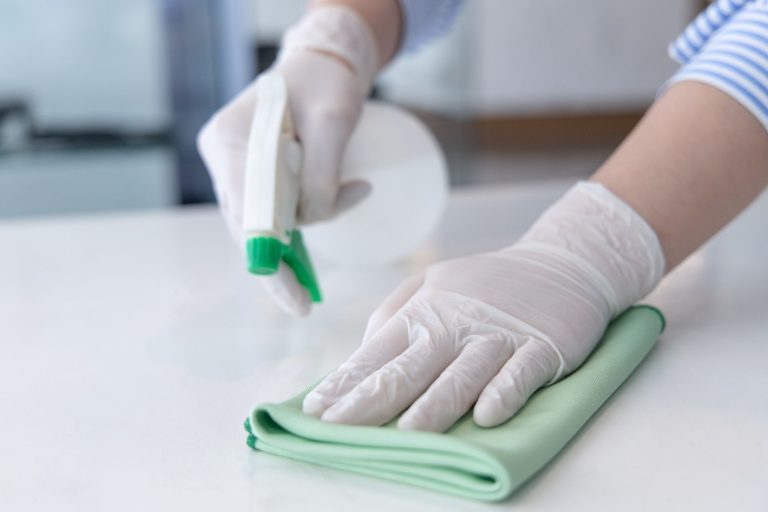 A person cleaning a countertop