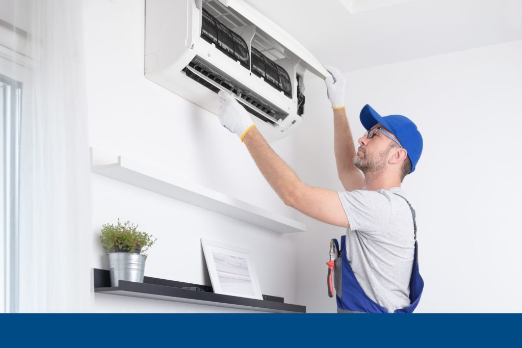 An HVAC technician servicing an AC unit