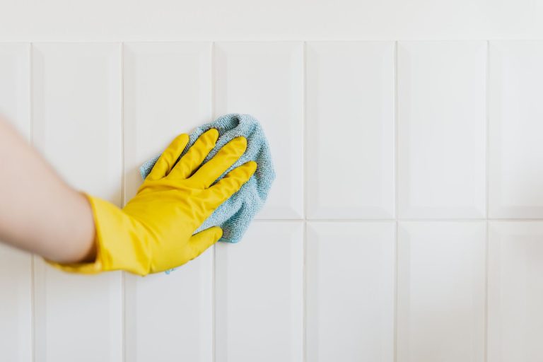 A person cleaning tile