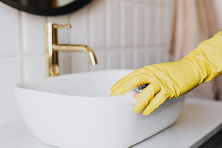 A person cleaning a sink