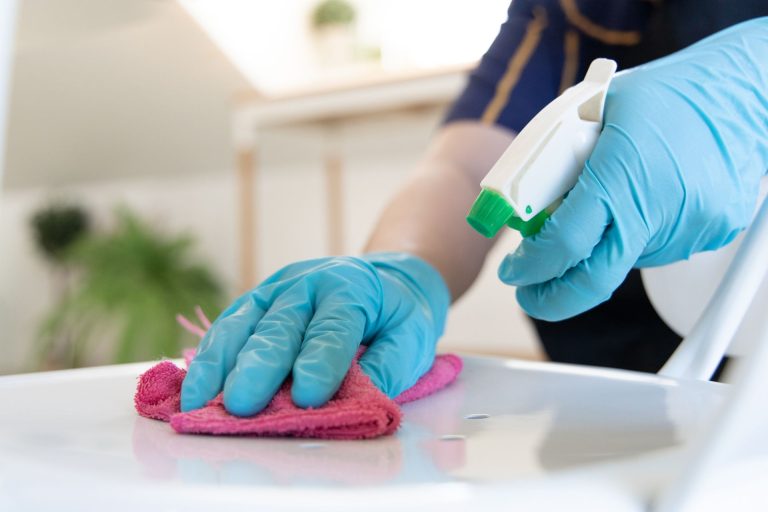 A person cleaning a table