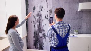 contractor and woman assessing water damage