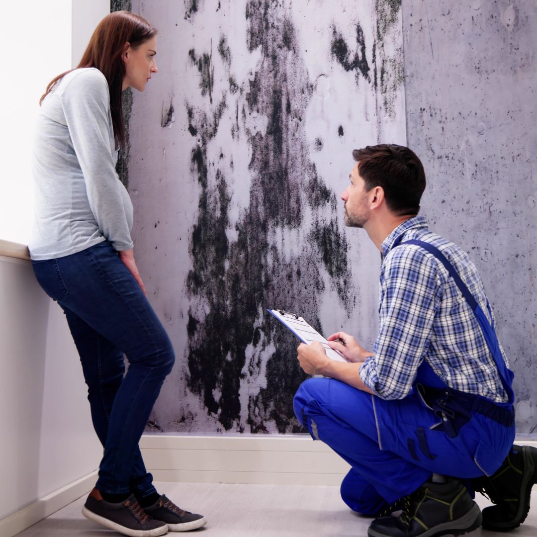 contractor with woman assessing water damage