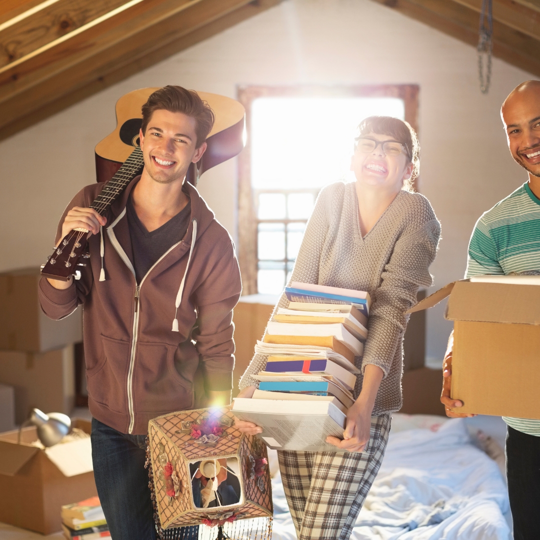 Man and woman cleaning their attic