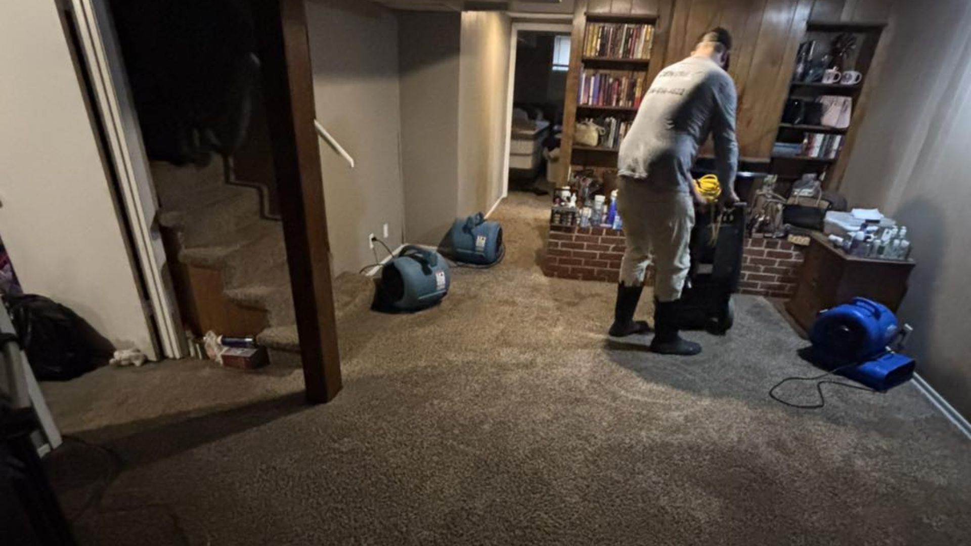 restoration worker in basement setting up
